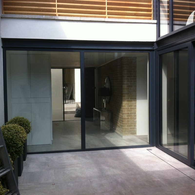 Floor-to-ceiling sliding doors opening to courtyard in Highbury