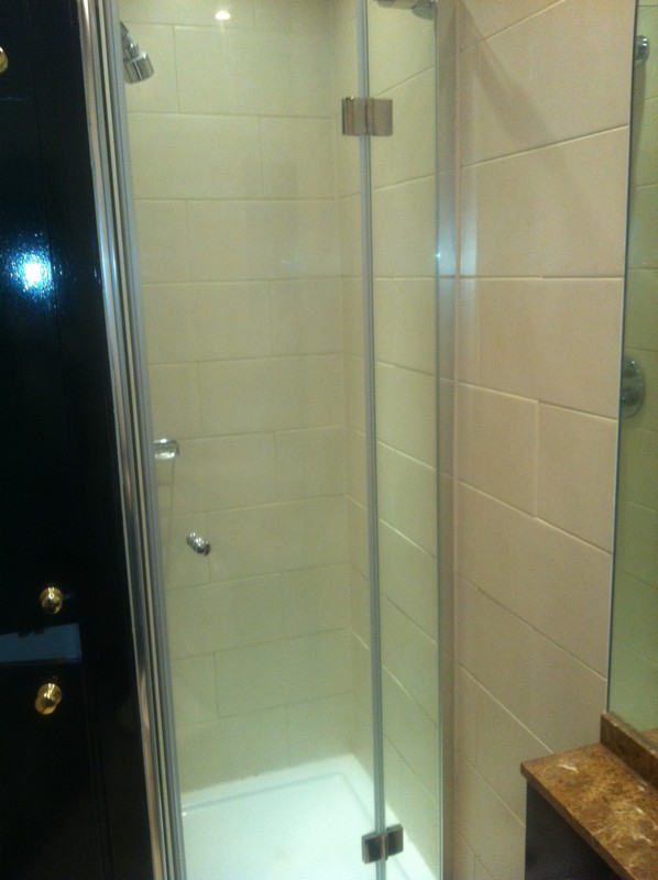 Frameless glass shower enclosure with chrome fittings in Highbury