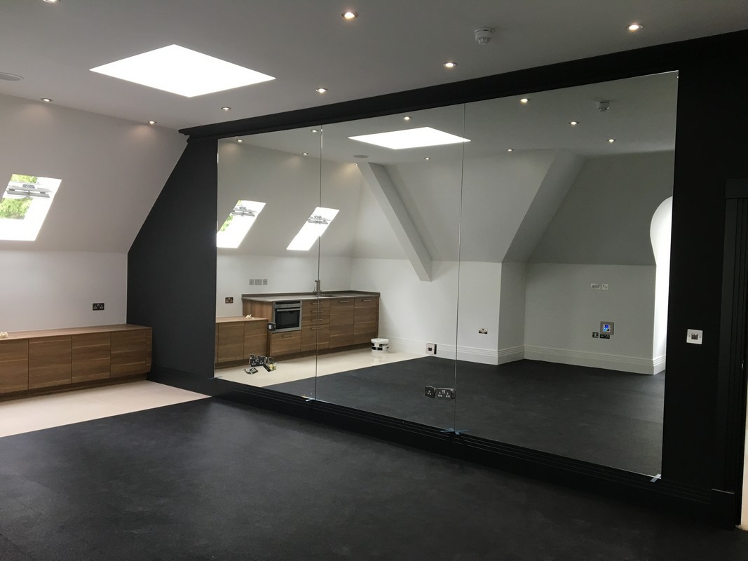 Frameless glass wall dividing loft conversion in Highbury