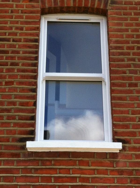 uPVC sash window on Victorian red brick house in Highbury